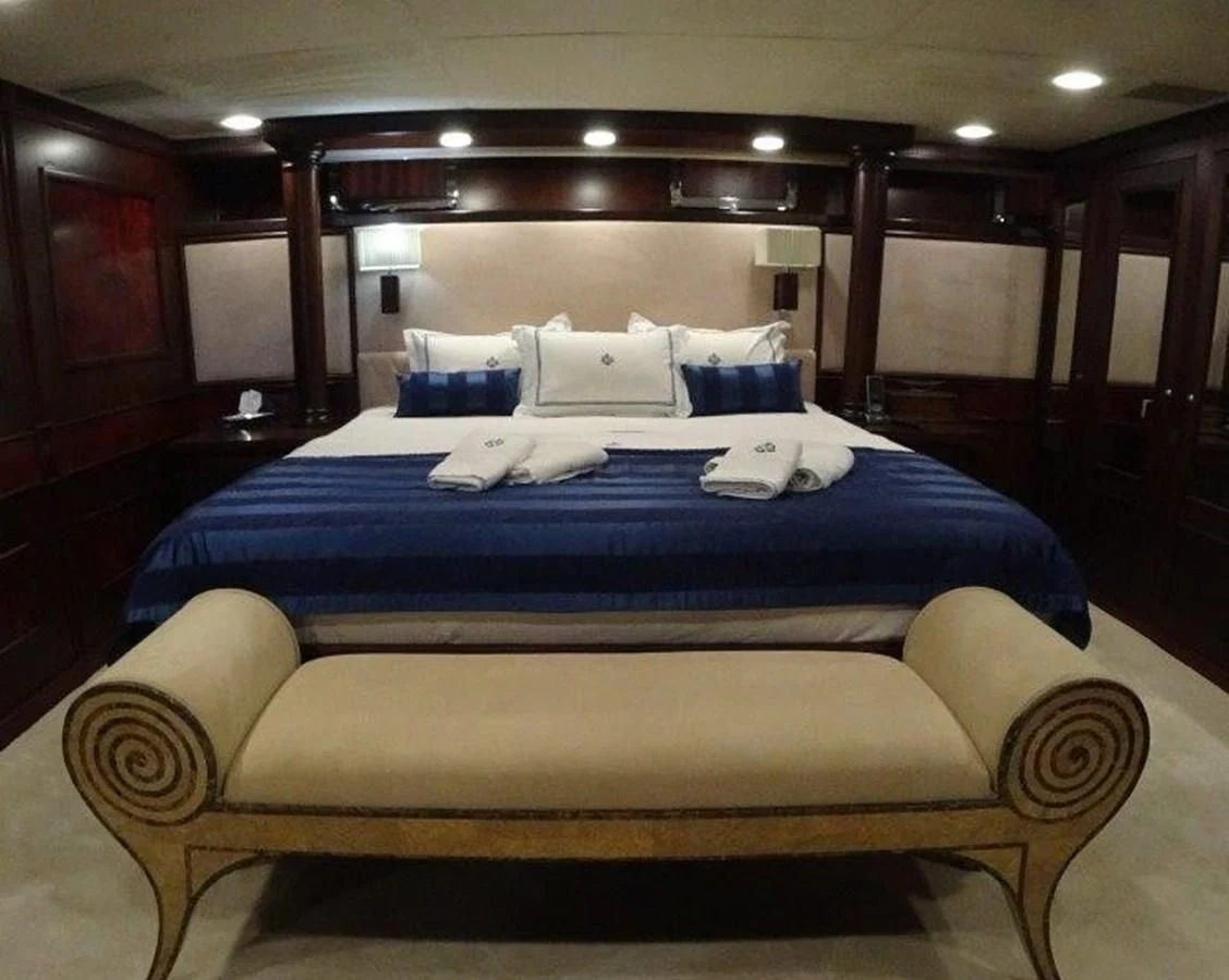 a bed with a blue sheet aboard AGA 6 Yacht for Sale