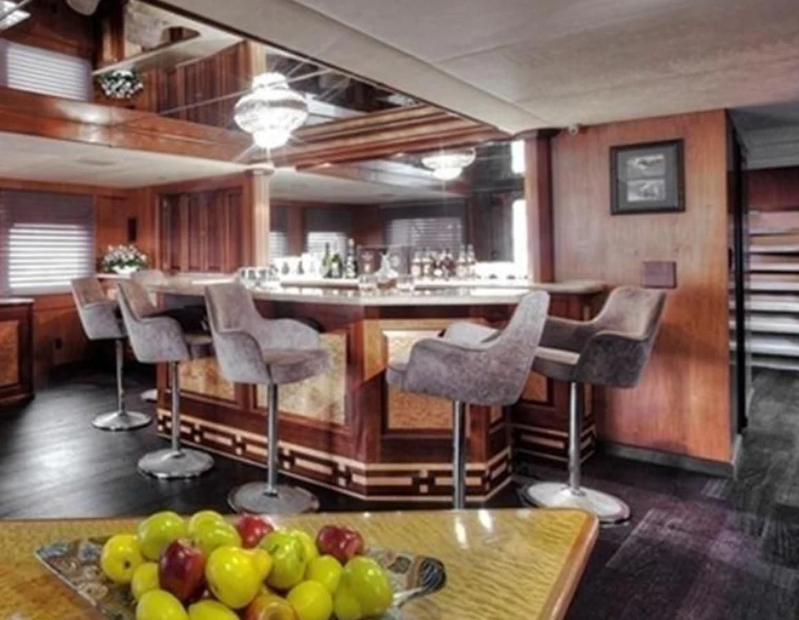 a kitchen with a table and chairs aboard AGA 6 Yacht for Sale