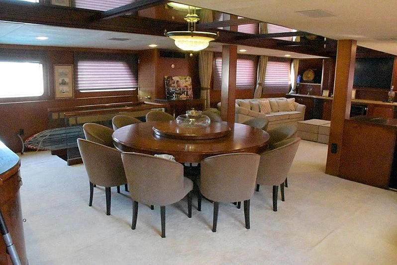 a room with a table and chairs aboard AGA 6 Yacht for Sale