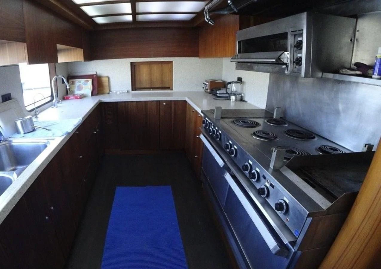 a kitchen with a blue and white floor aboard AGA 6 Yacht for Sale