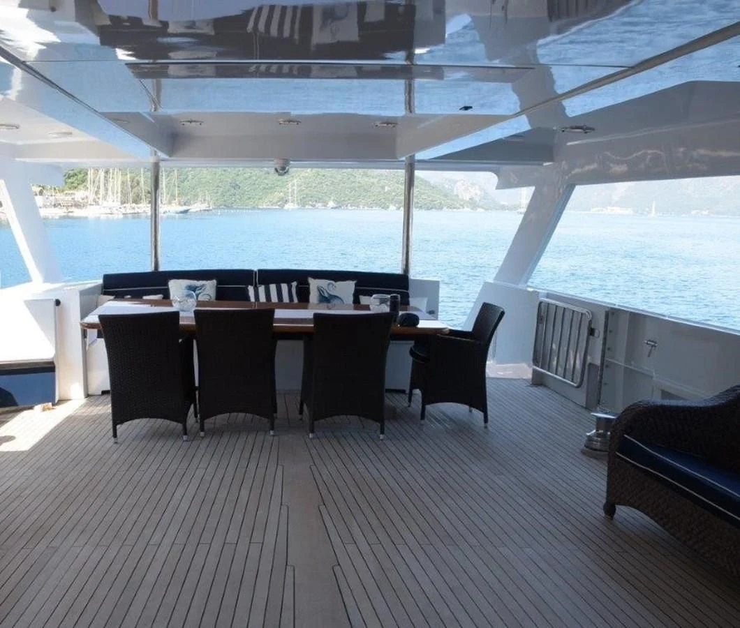 a room with a table and chairs aboard AGA 6 Yacht for Sale