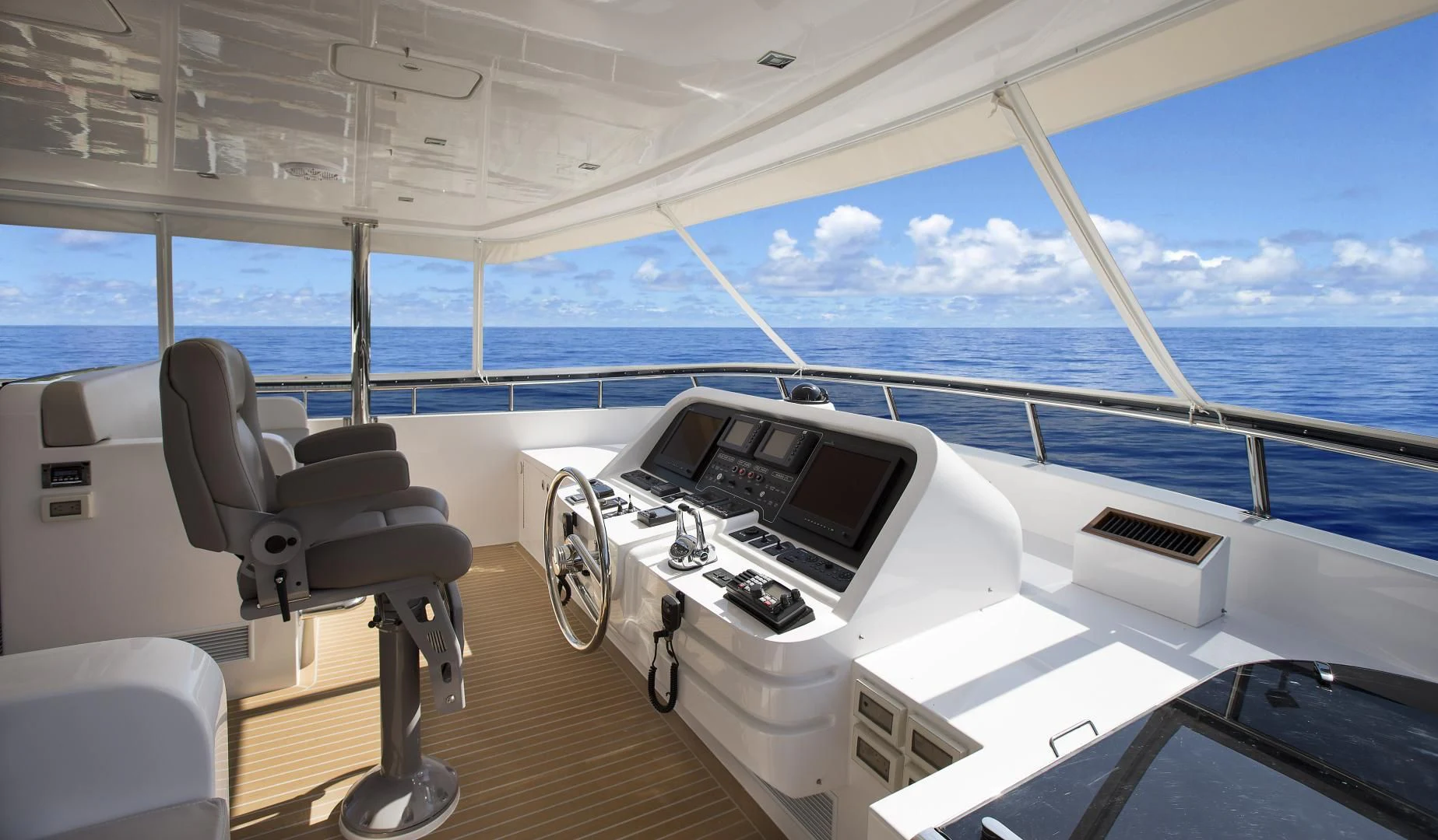 a room with a large window and a table with chairs and a computer on it aboard SEASEID Yacht for Sale