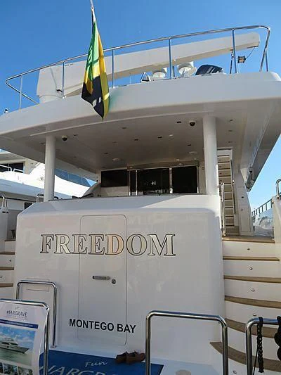 a boat with a flag on the deck aboard SEASEID Yacht for Sale