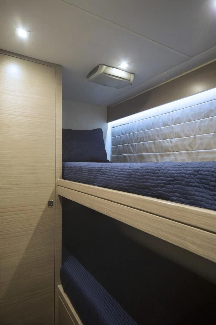 a bed with a blue comforter aboard SEASEID Yacht for Sale