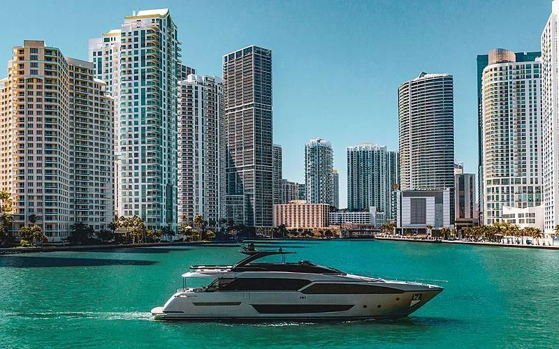 a boat in the water with a city in the background aboard SLAVA Yacht for Sale