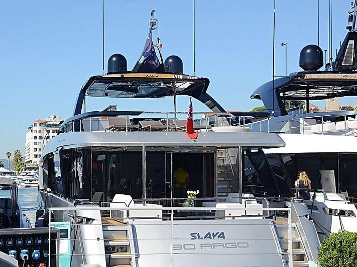 a large boat with a statue on top aboard SLAVA Yacht for Sale