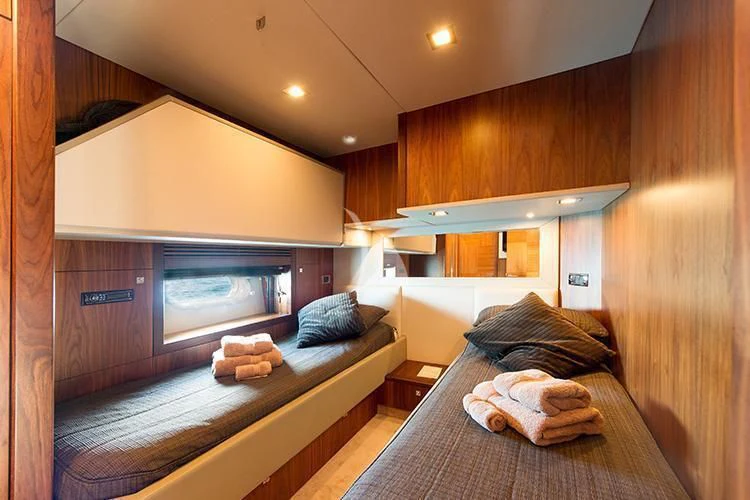 a room with a bed and a television aboard NEMESIS Yacht for Sale