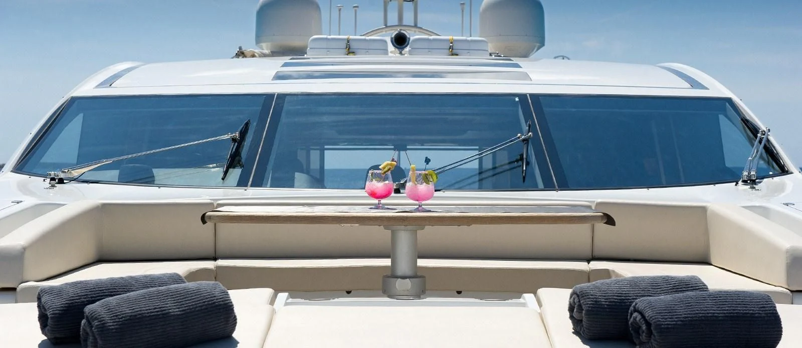 a white car with a table and chairs on the deck aboard NEMESIS Yacht for Sale