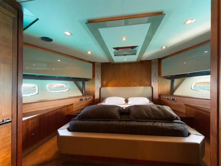 a room with a bed and a window aboard NEMESIS Yacht for Sale