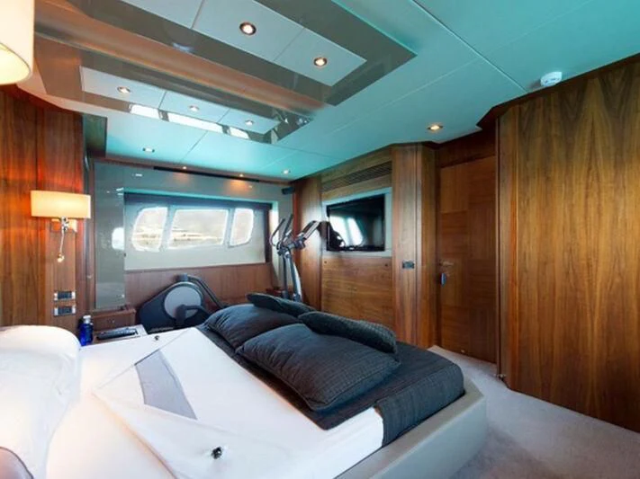 a room with a bed and a television aboard NEMESIS Yacht for Sale