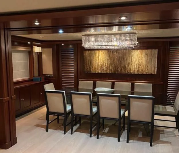 a room with a table and chairs aboard PALATIAL Yacht for Sale