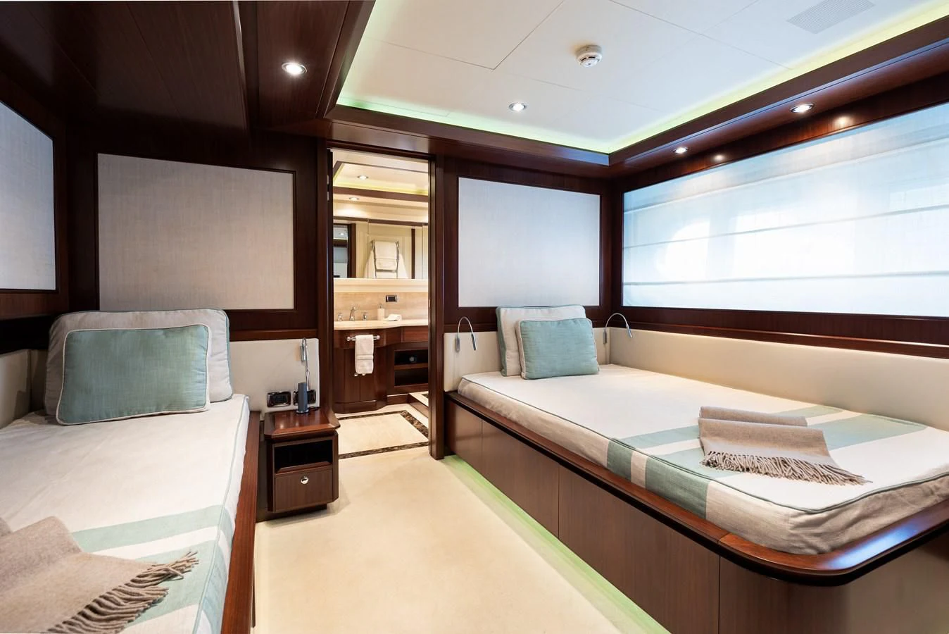 a room with a bed and a window aboard PALATIAL Yacht for Sale