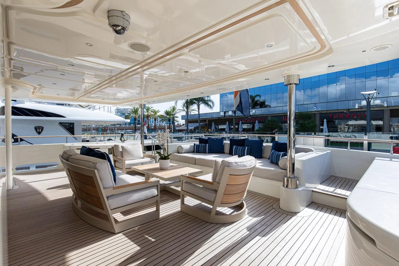 a lounge area with a lounge chair and a pool aboard PALATIAL Yacht for Sale