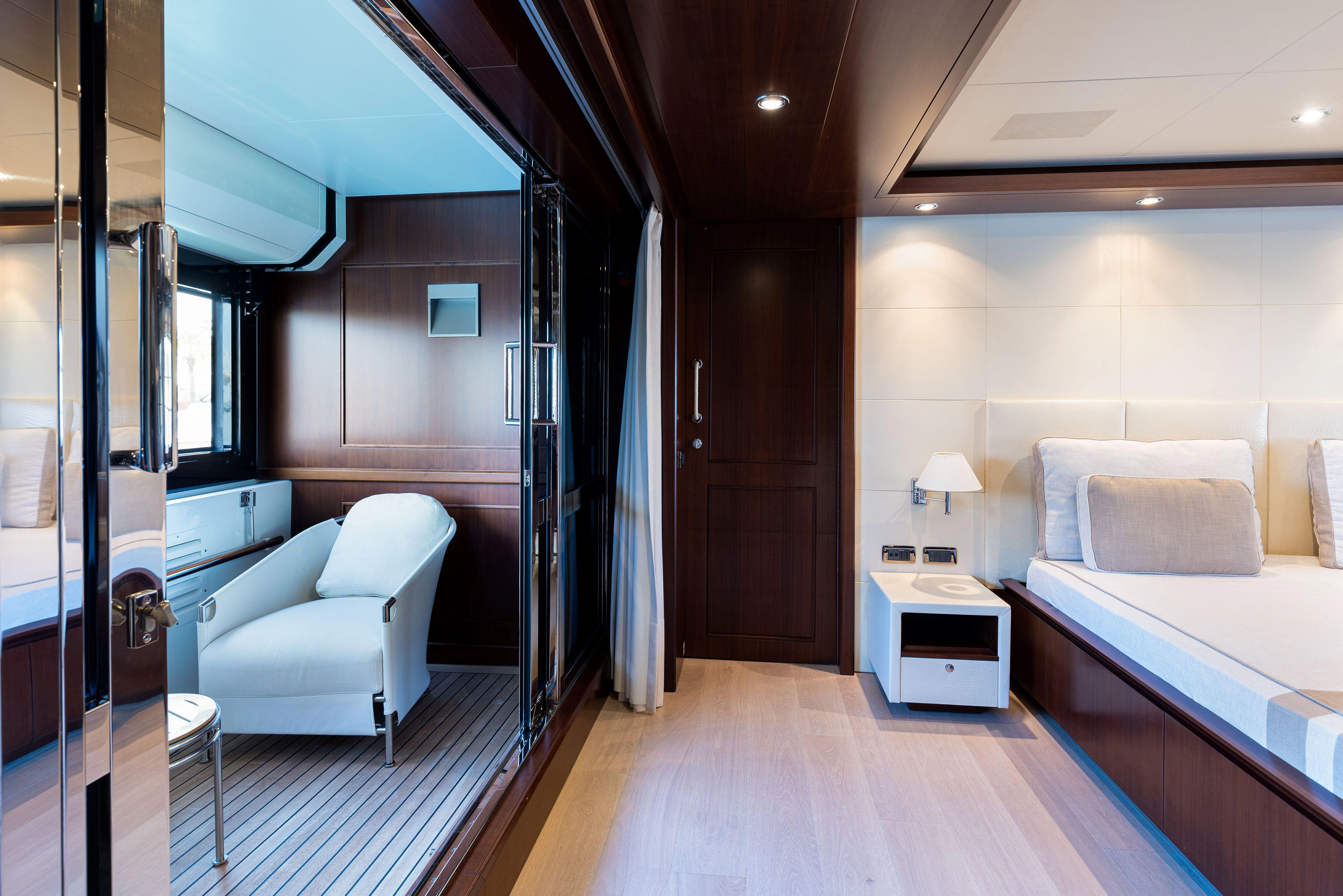 a room with a bed and a desk aboard PALATIAL Yacht for Sale