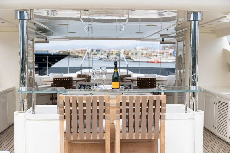 a wine bottle on a table aboard PALATIAL Yacht for Sale