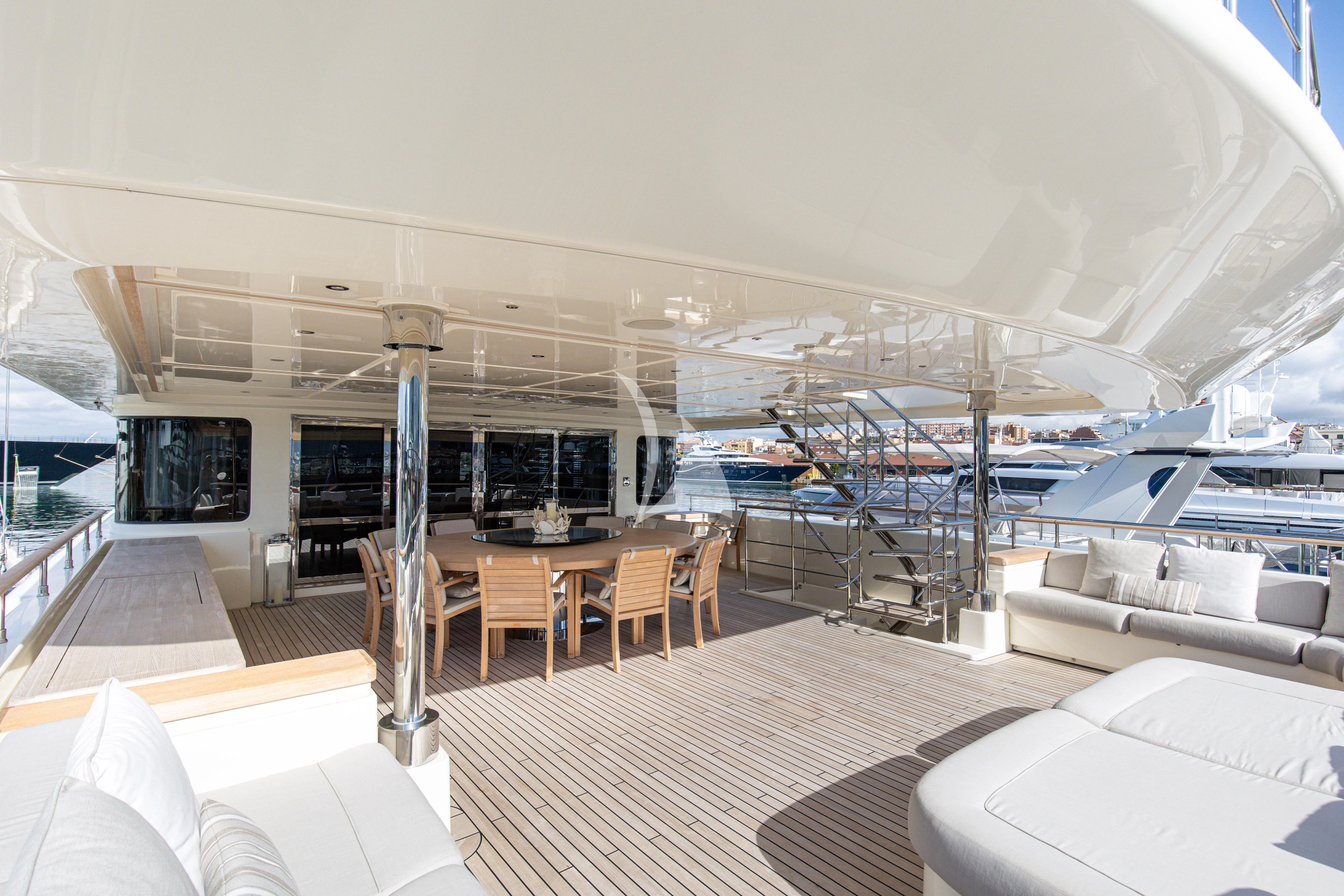 a room with a table and chairs aboard PALATIAL Yacht for Sale