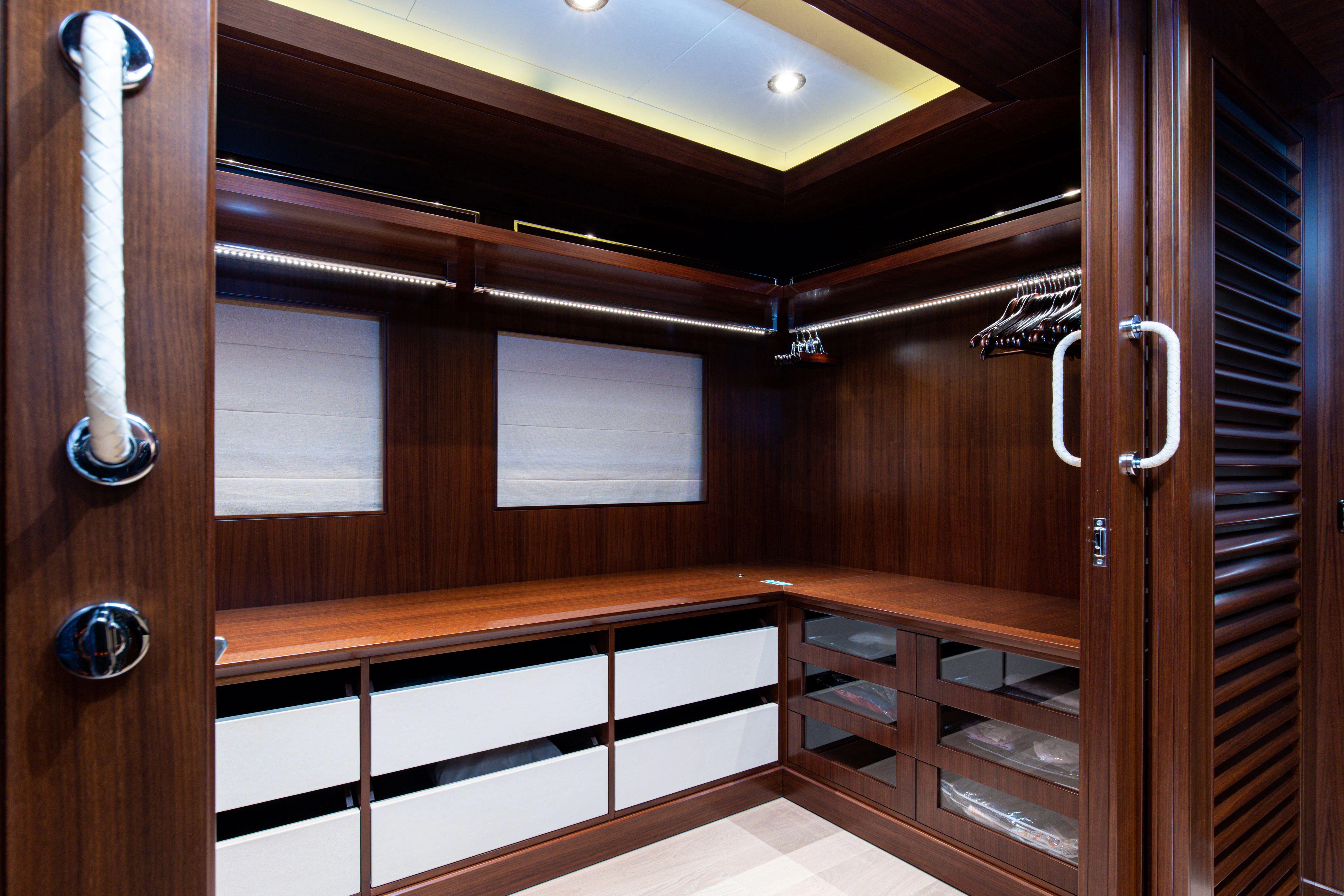 a room with wooden cabinets aboard PALATIAL Yacht for Sale