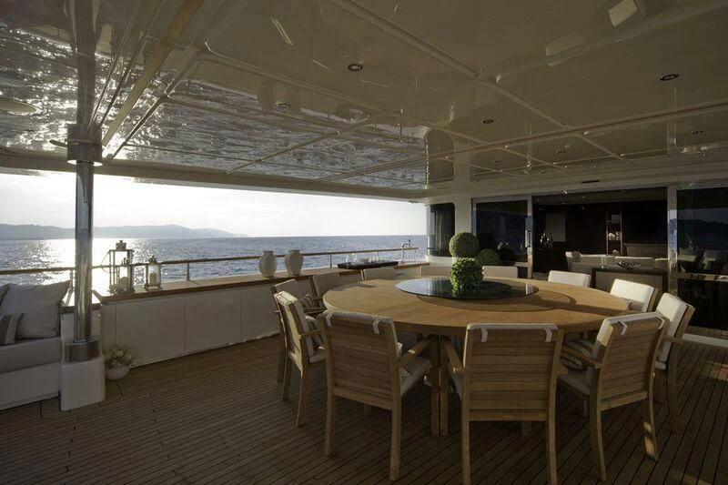 a room with a table and chairs aboard PALATIAL Yacht for Sale