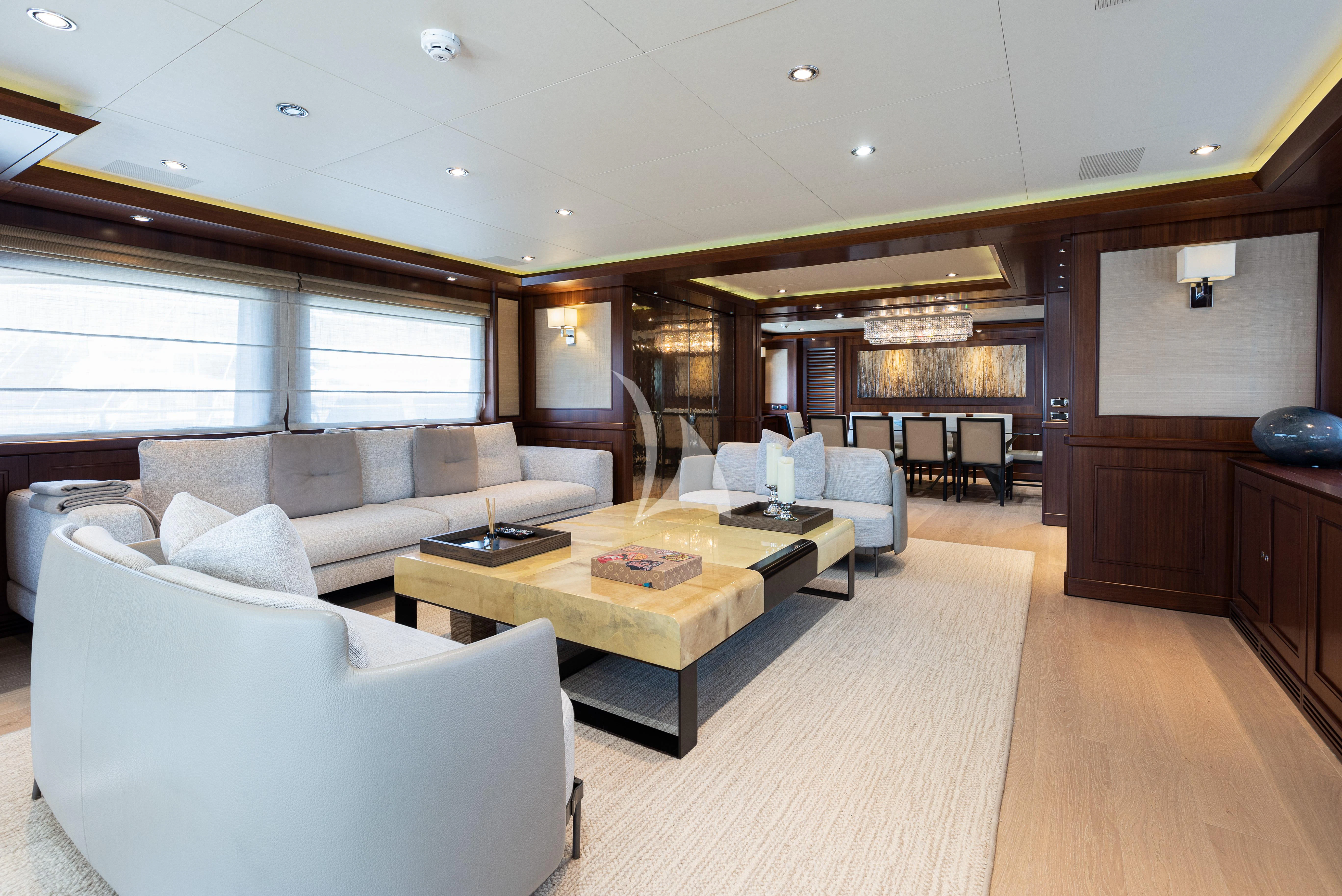 a living room with a couch and a table aboard PALATIAL Yacht for Sale