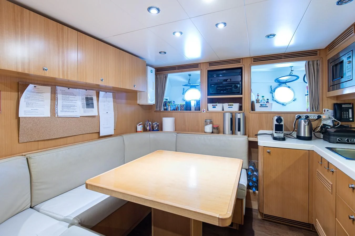 a kitchen with a table and a couch aboard PALATIAL Yacht for Sale