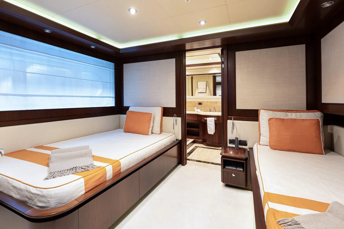 a room with a bed and a desk aboard PALATIAL Yacht for Sale