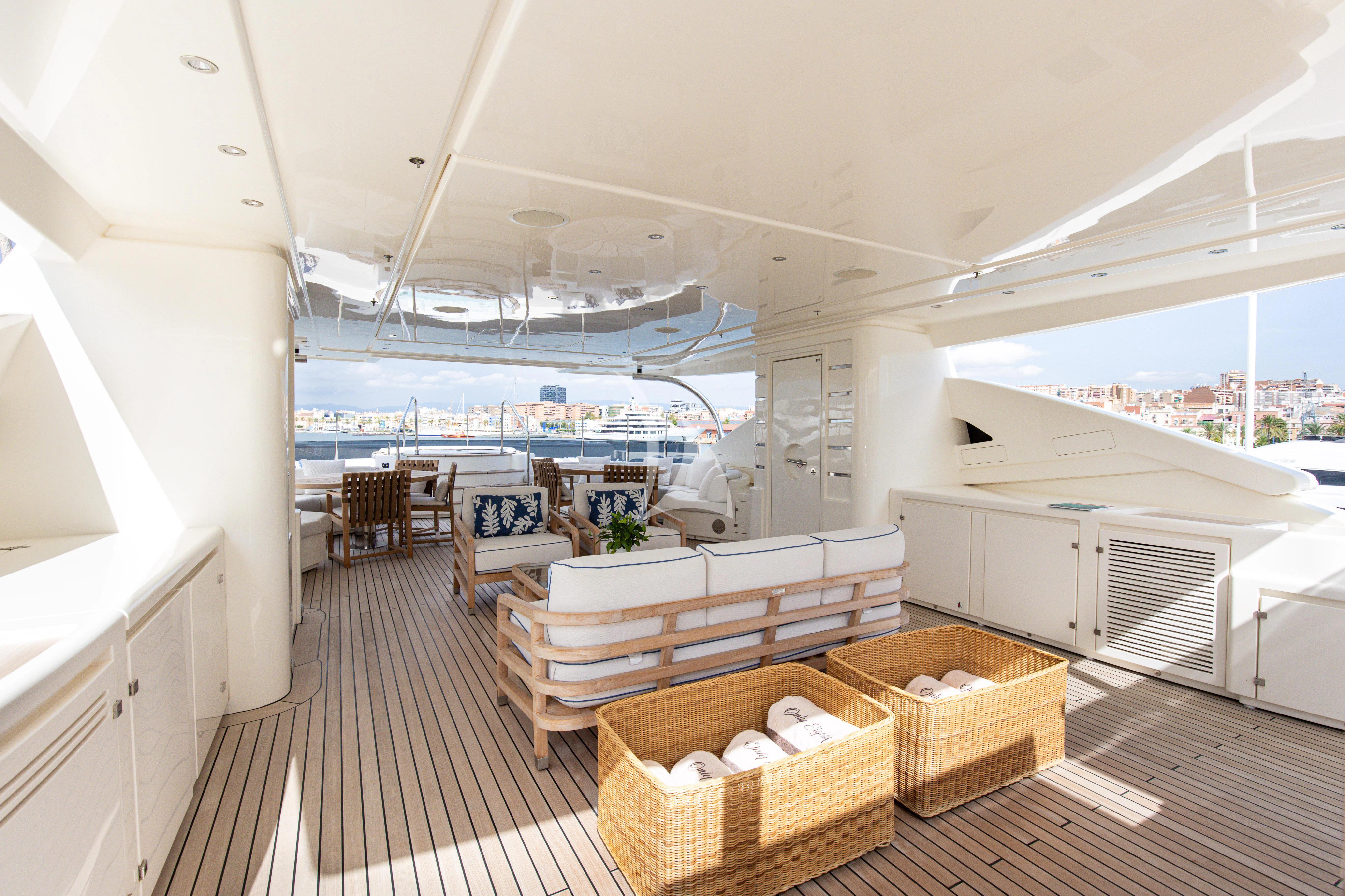 a room with a bench and a table and chairs aboard PALATIAL Yacht for Sale