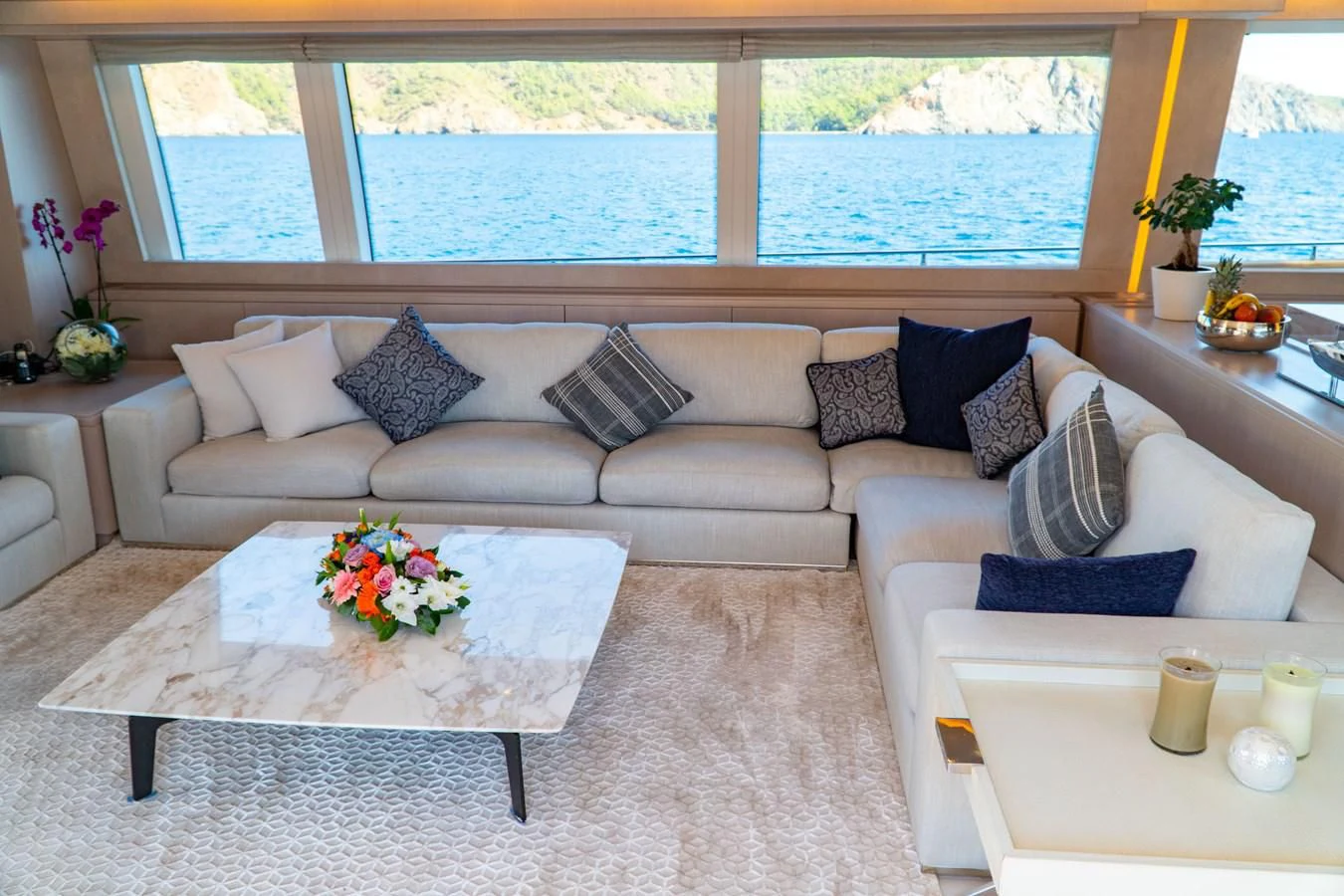 a living room with a couch and a table aboard SHELLS X Yacht for Sale
