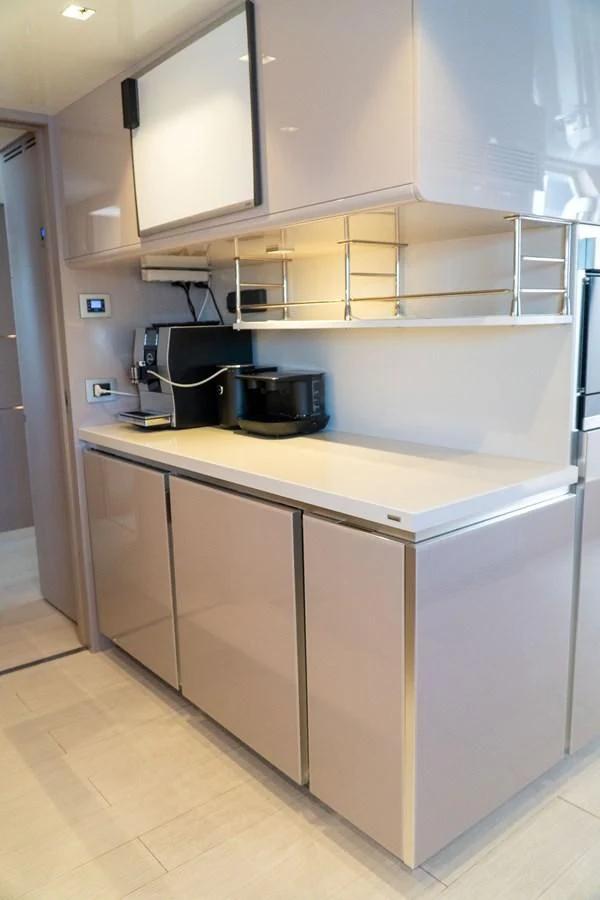 a kitchen with white cabinets aboard SHELLS X Yacht for Sale