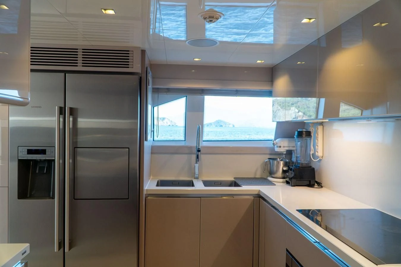 a kitchen with a refrigerator and sink aboard SHELLS X Yacht for Sale