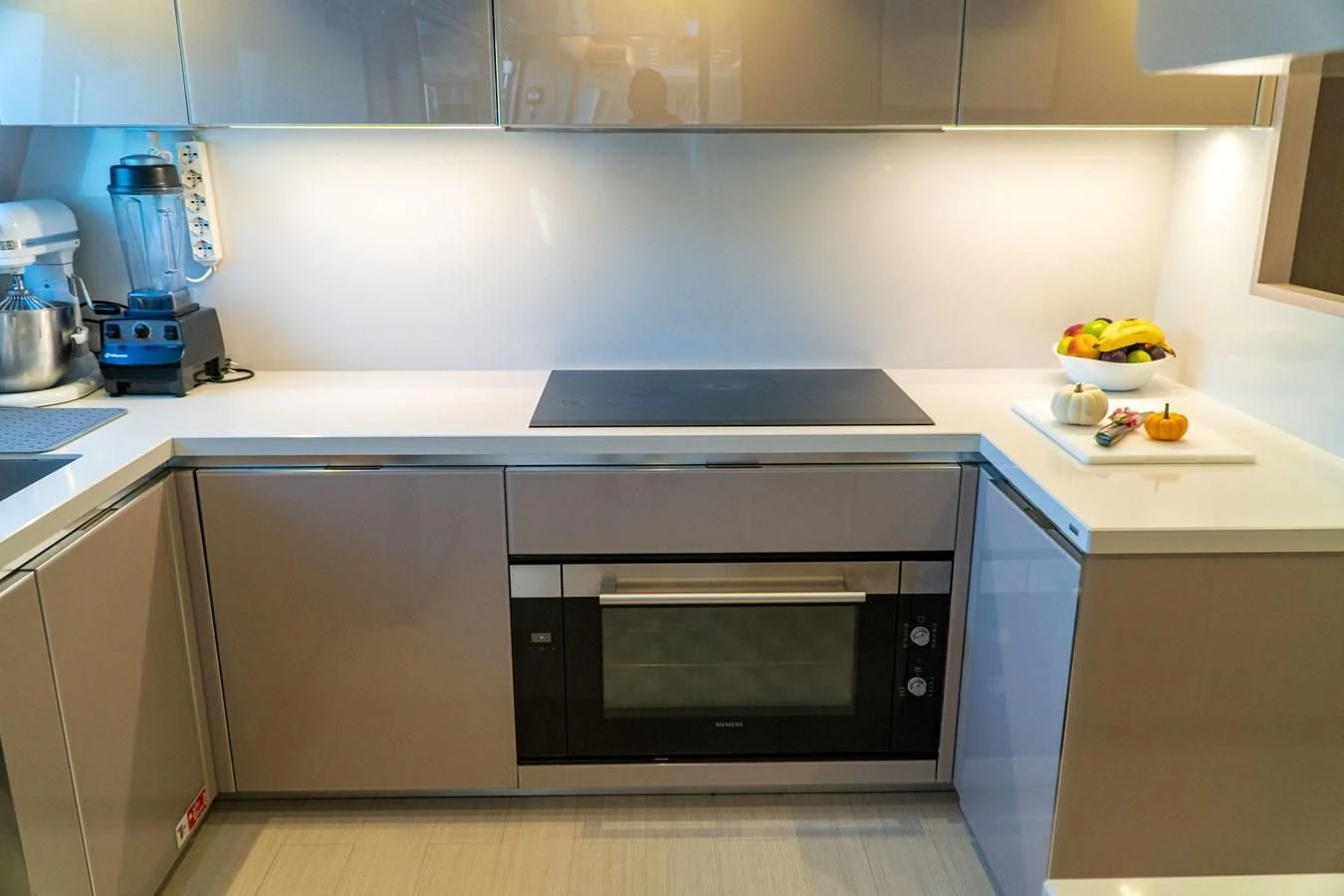 a kitchen with white cabinets aboard SHELLS X Yacht for Sale