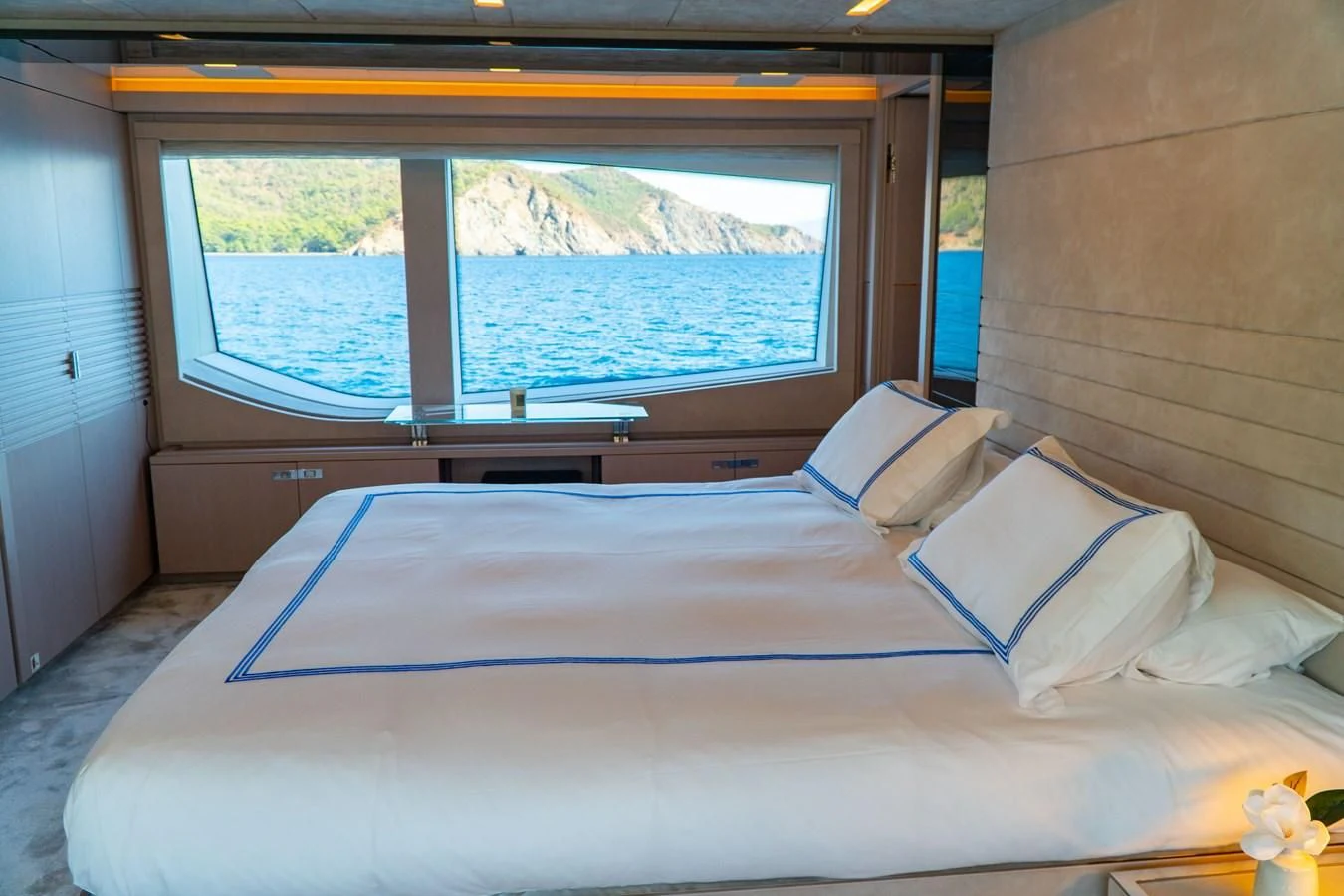 a bed with a blue sheet aboard SHELLS X Yacht for Sale