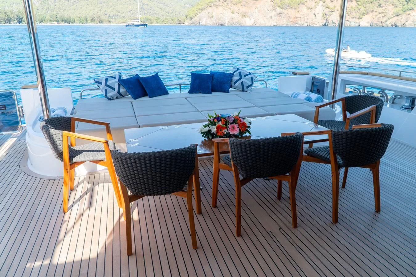 a table and chairs on a deck aboard SHELLS X Yacht for Sale