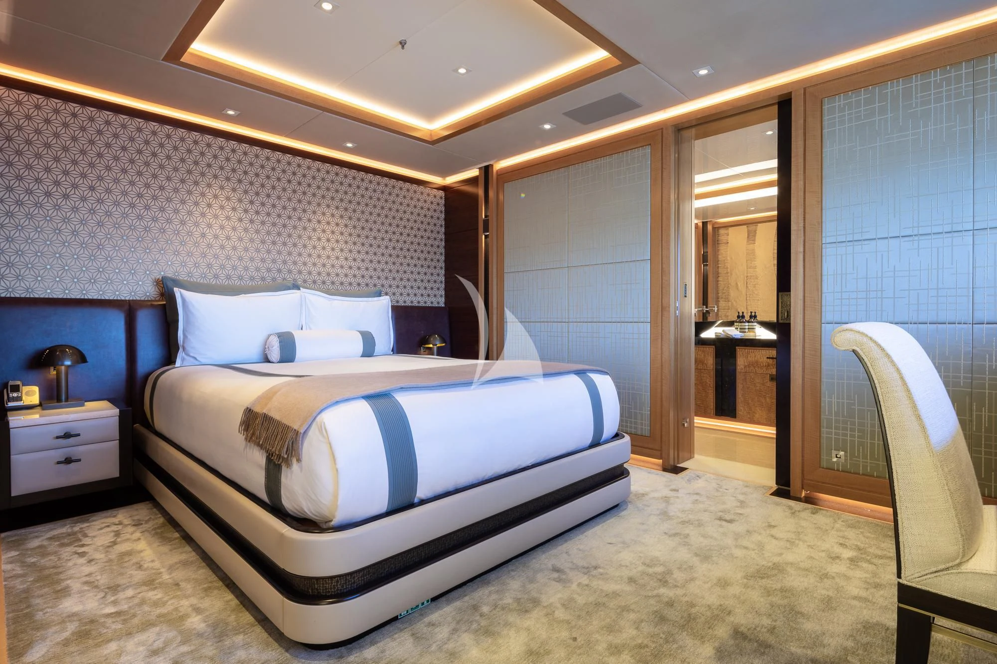 a bedroom with a bed and a chair aboard FORMOSA Yacht for Sale