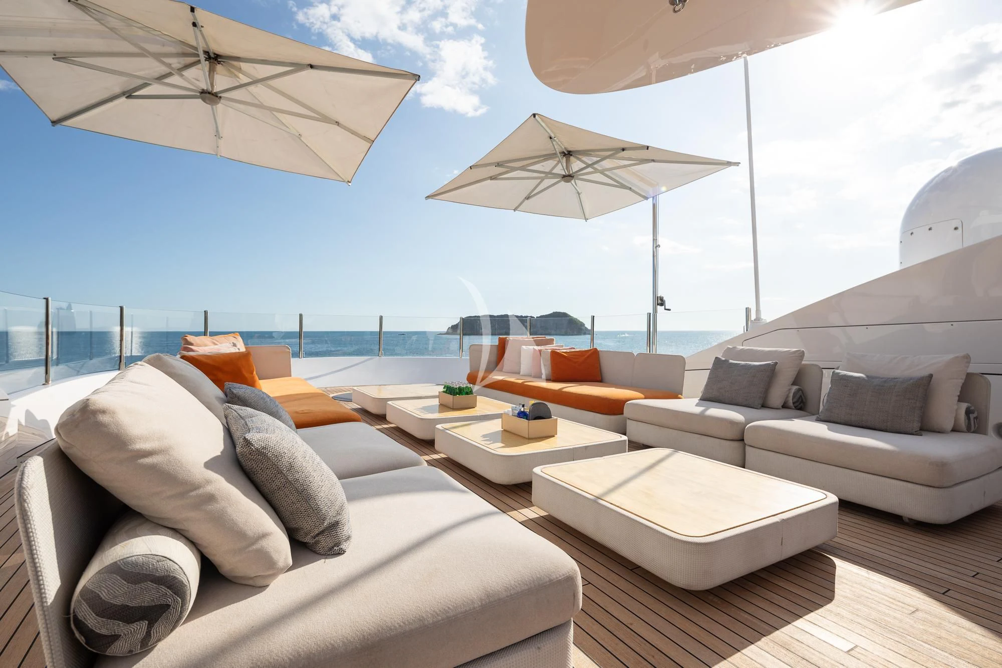 a large lounge area with a large lounge chair and a large umbrella aboard FORMOSA Yacht for Sale