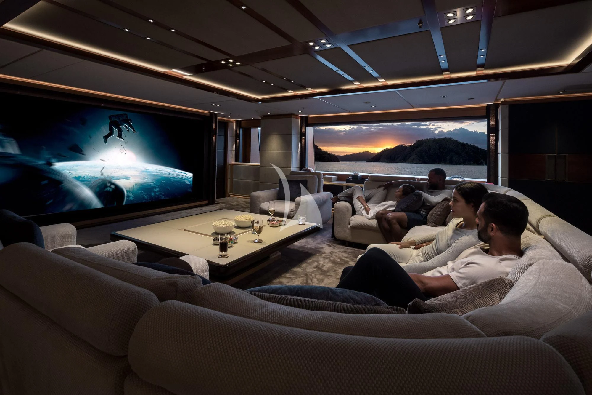 a group of people sitting on a couch watching a television aboard FORMOSA Yacht for Sale