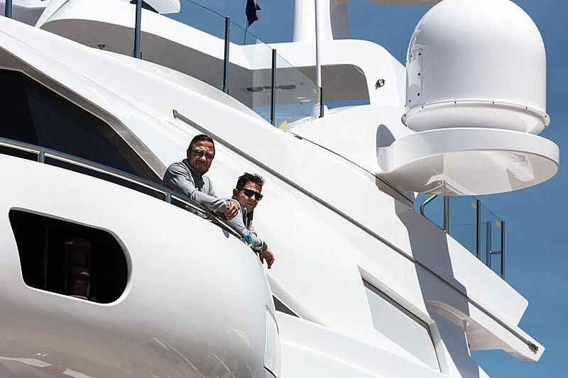 a man and woman sitting on a white yacht aboard FORMOSA Yacht for Sale
