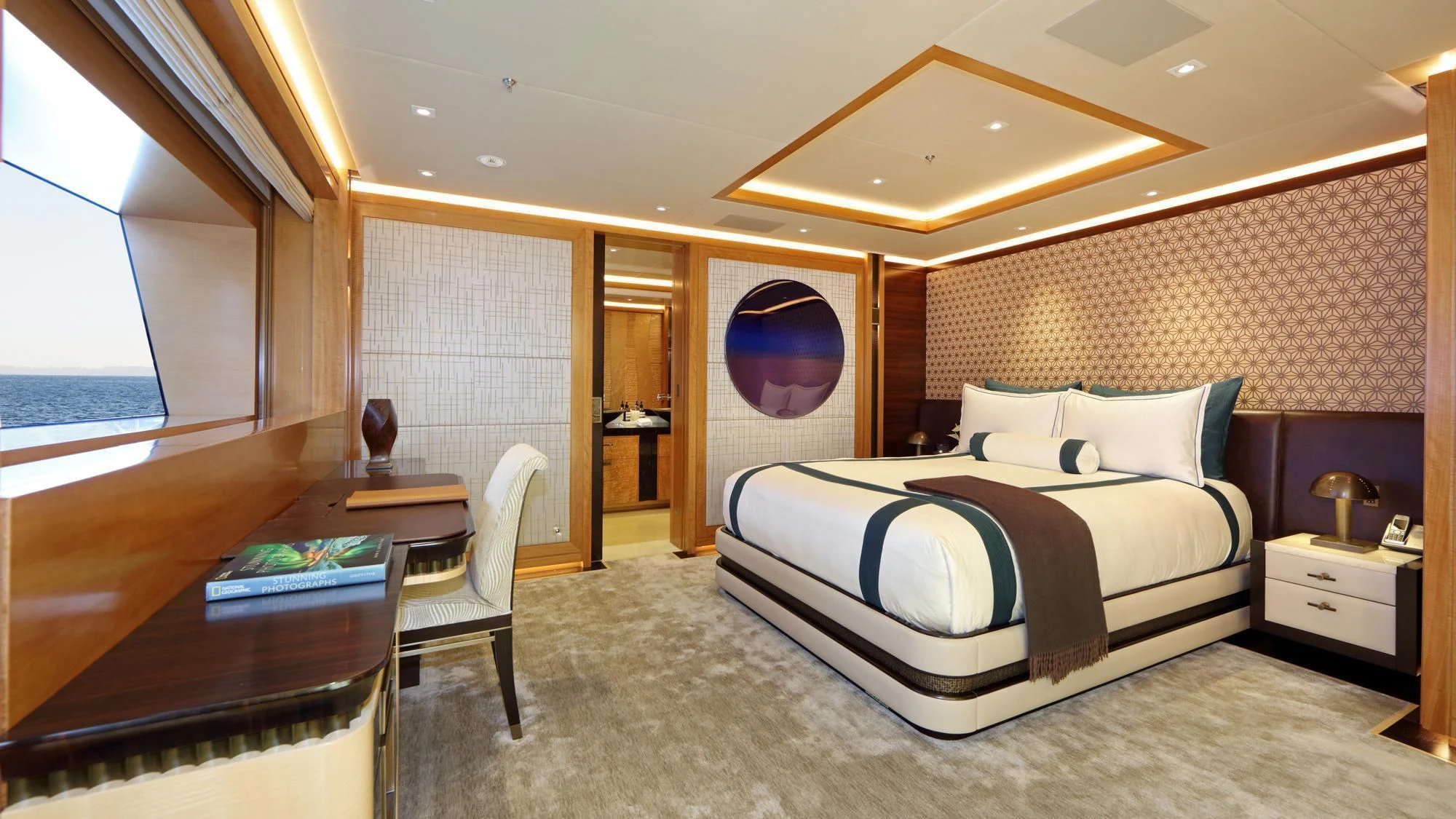 a bedroom with a bed and a desk aboard FORMOSA Yacht for Sale