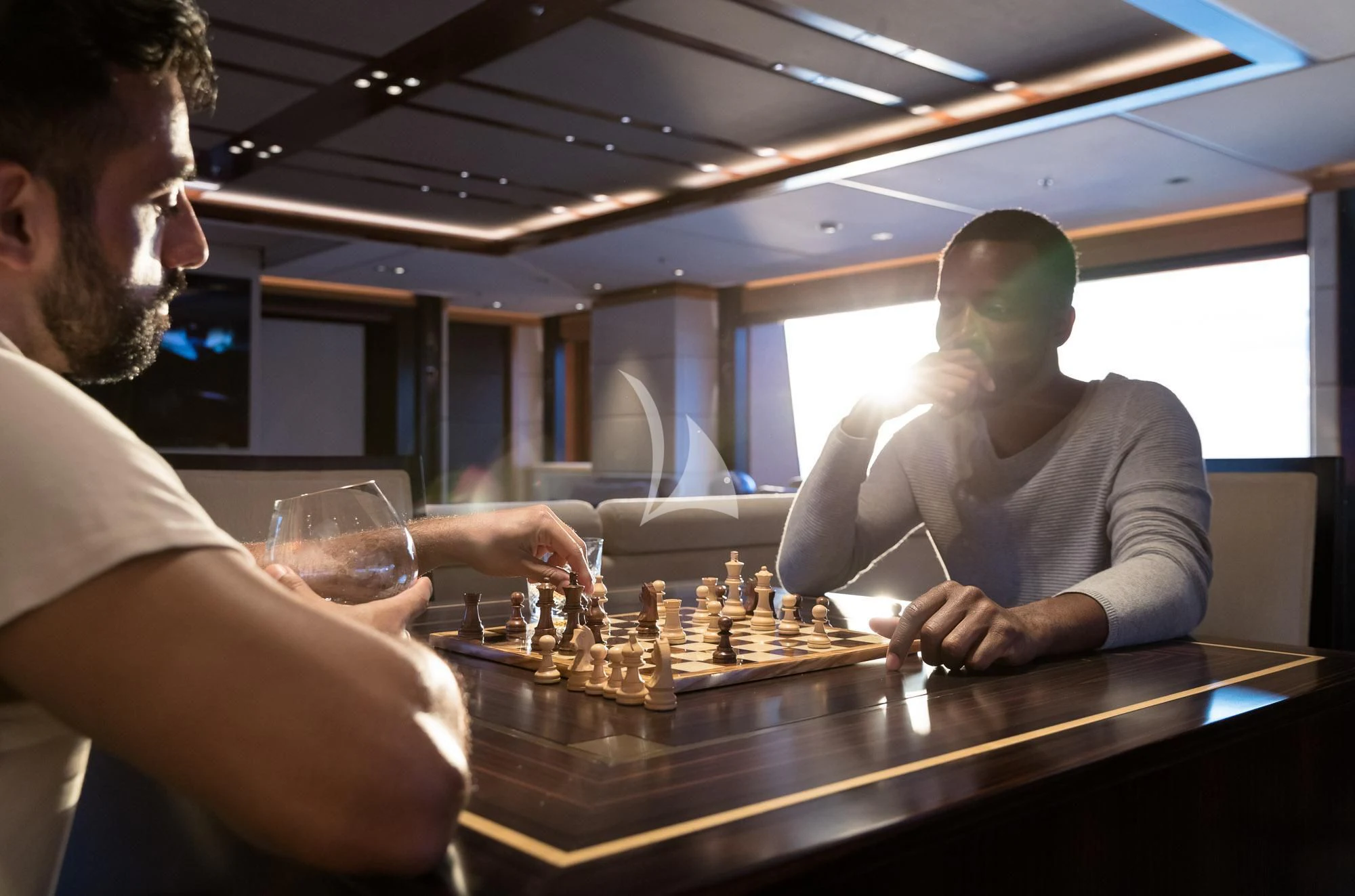 a man and a woman playing chess aboard FORMOSA Yacht for Sale