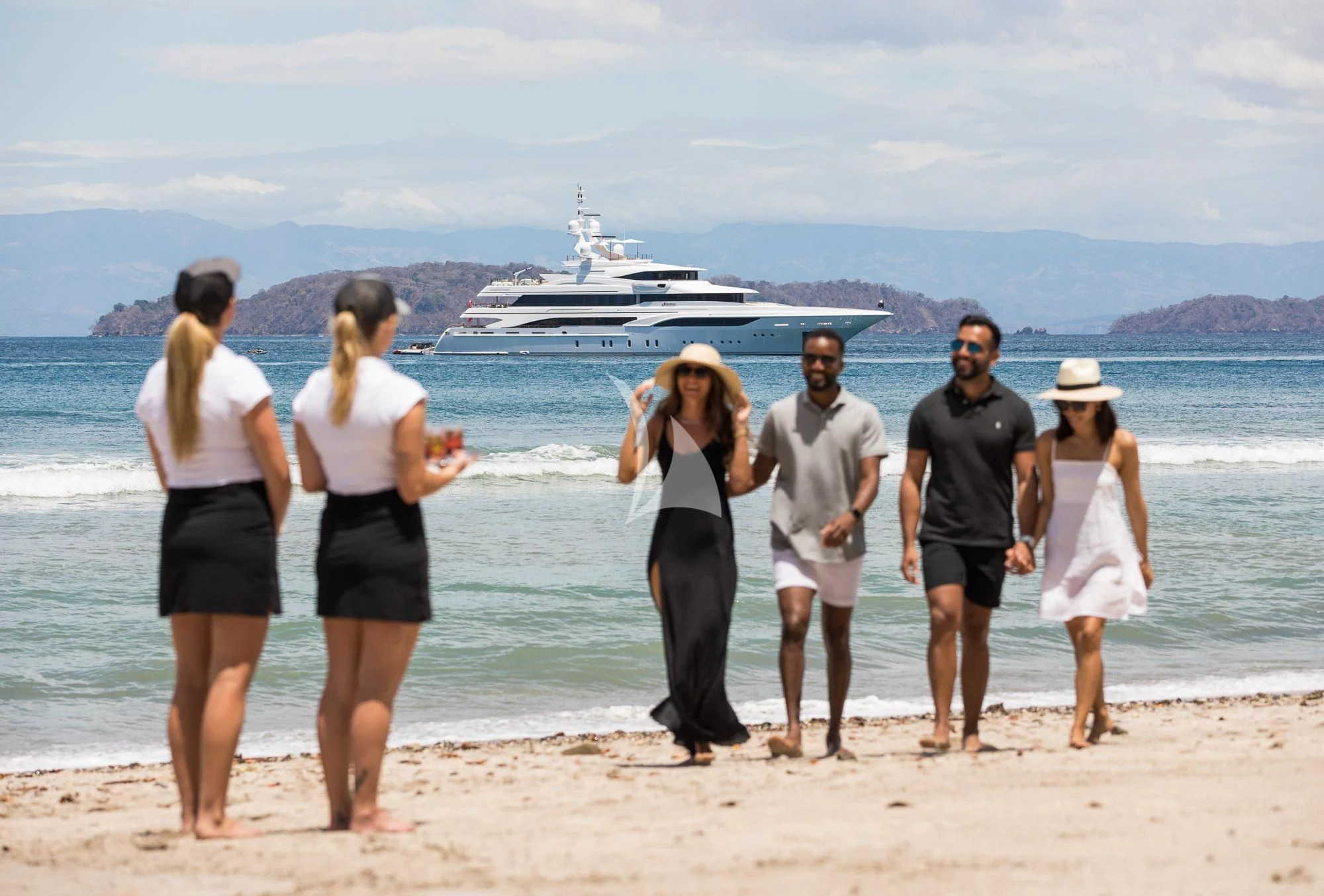 a group of people on a beach aboard FORMOSA Yacht for Sale