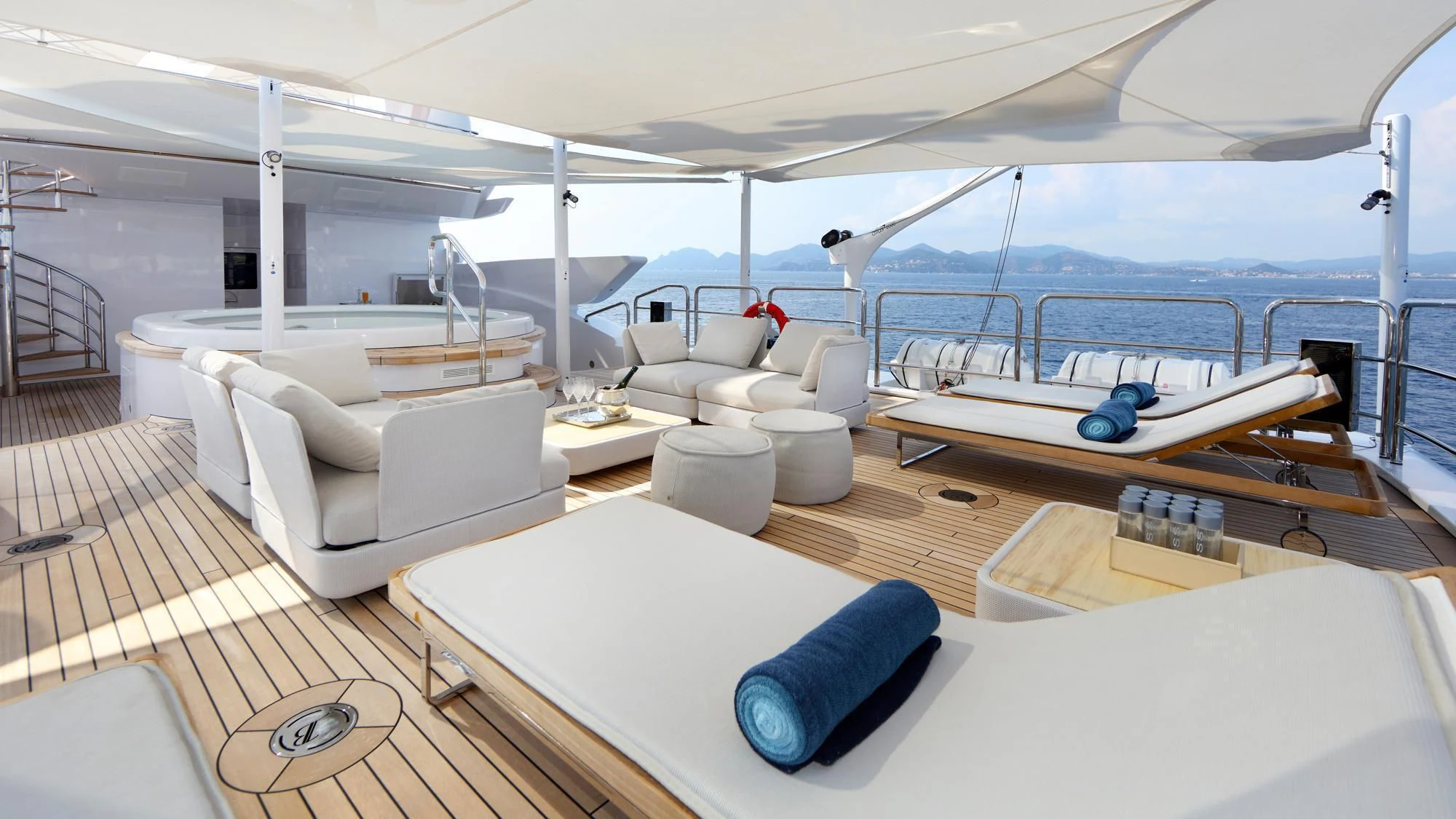 a large white boat with a large white lounge chair and a large white sofa on a deck with aboard FORMOSA Yacht for Sale