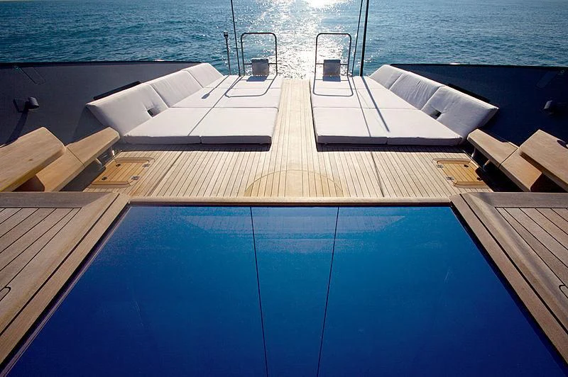 a deck with a large pool aboard ESENSE Yacht for Sale