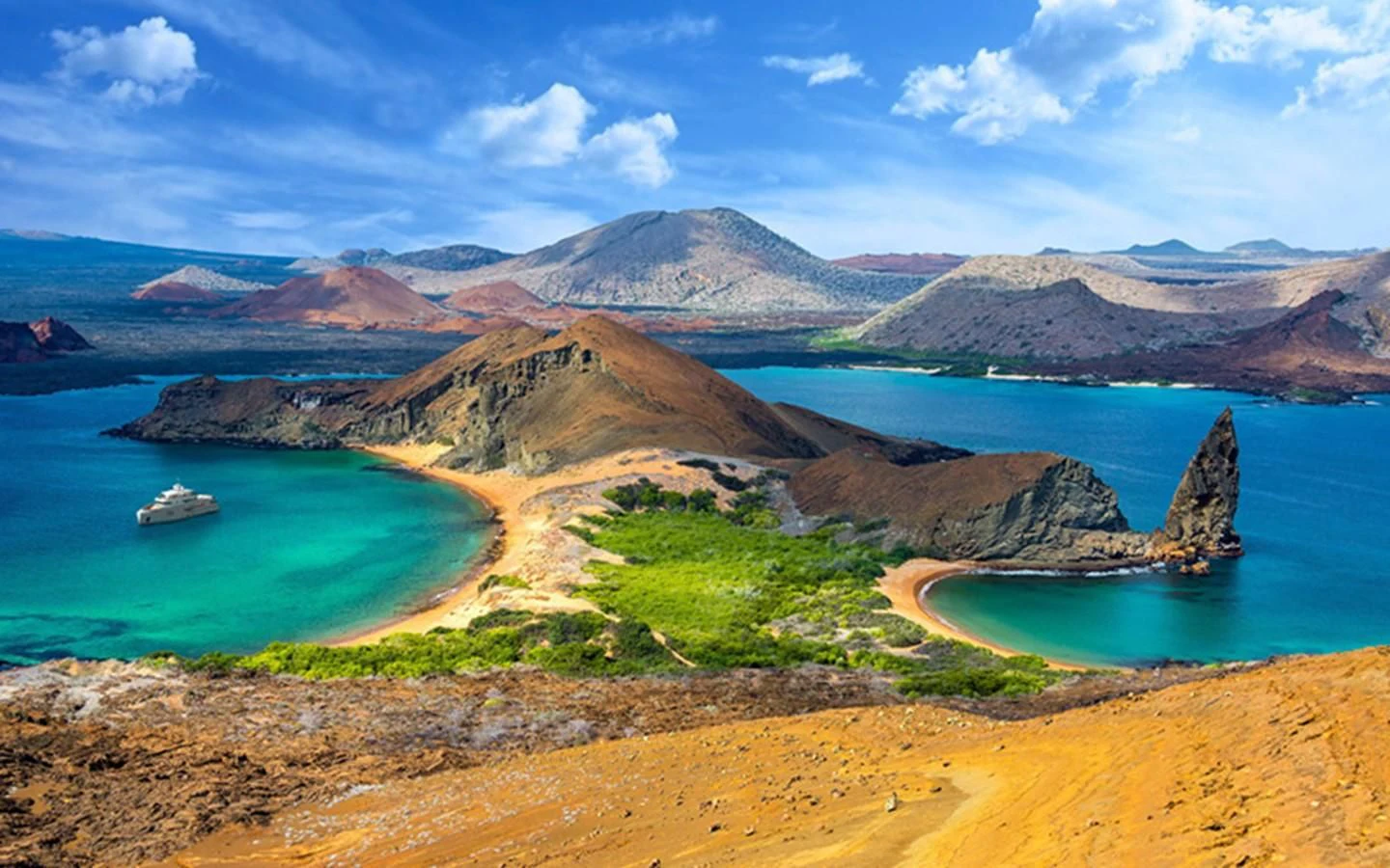 a beach with a body of water and mountains in the background aboard CAPE HAWK 690 Yacht for Sale