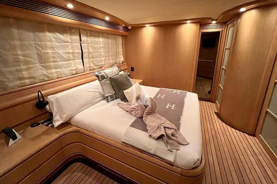 a bed with a towel on it aboard B4 Yacht for Charter