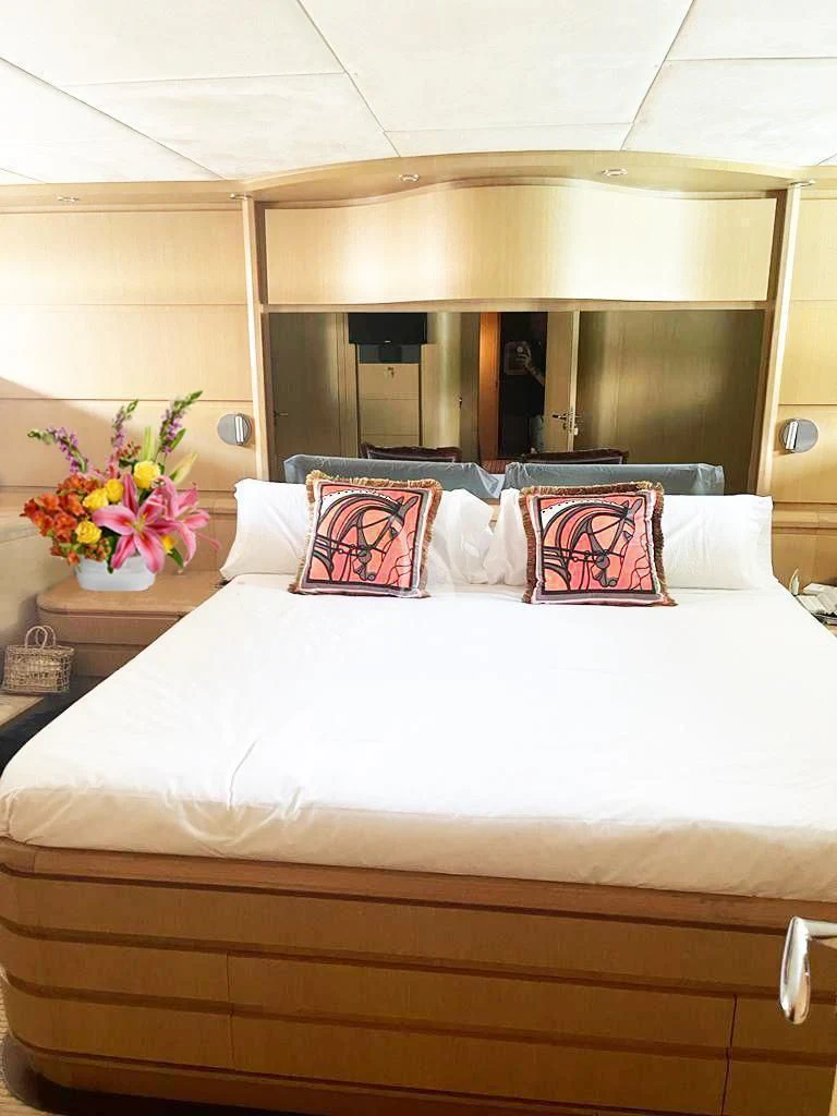 a bed with a white bed spread aboard B4 Yacht for Charter