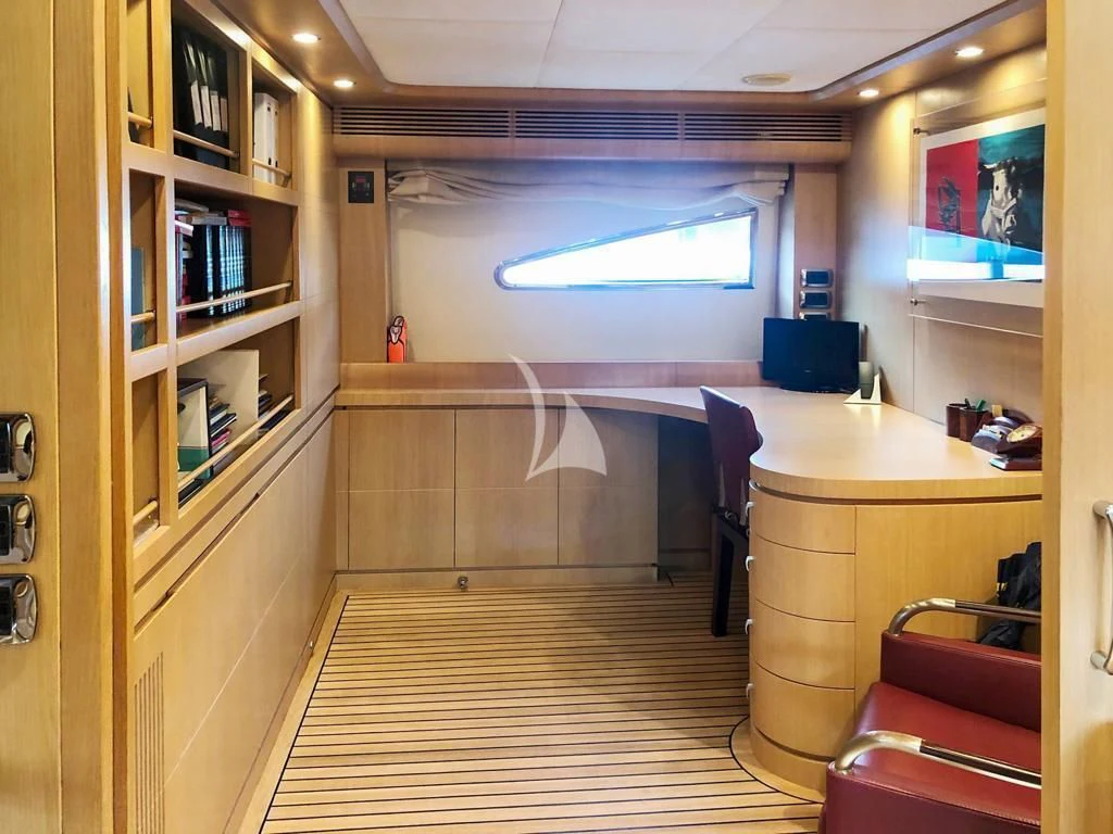 a room with a desk and a book shelf aboard B4 Yacht for Charter