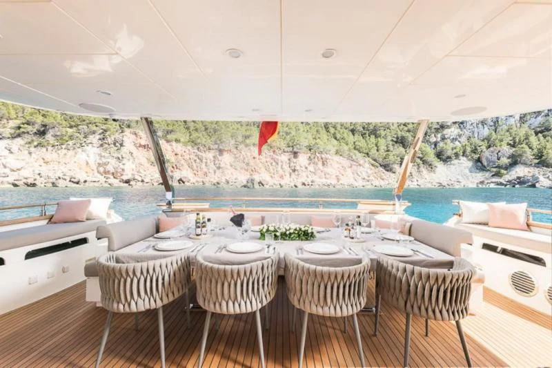 a room with tables and chairs aboard B4 Yacht for Charter