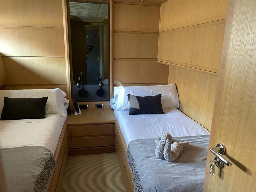 a room with a bed and a mirror aboard B4 Yacht for Charter
