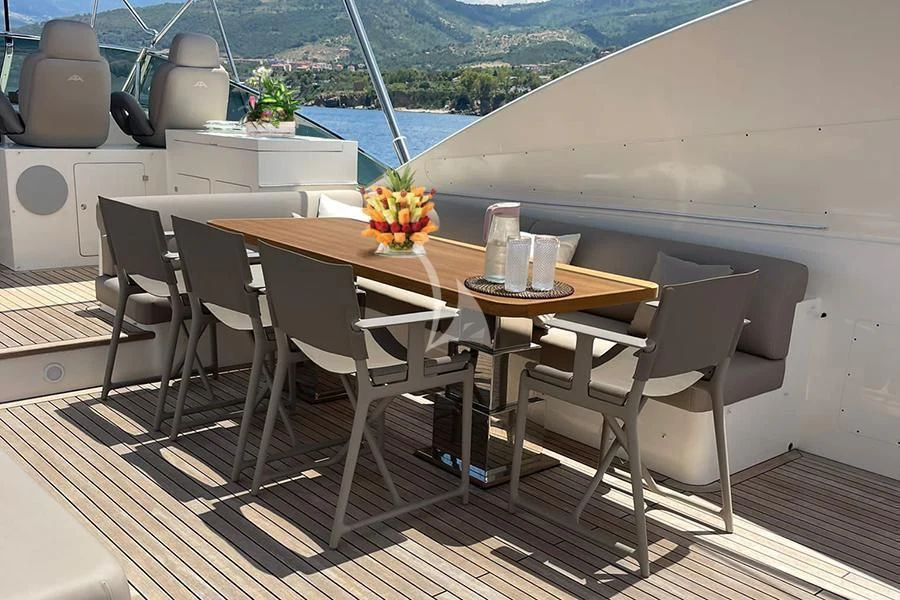a table and chairs on a deck aboard B4 Yacht for Charter