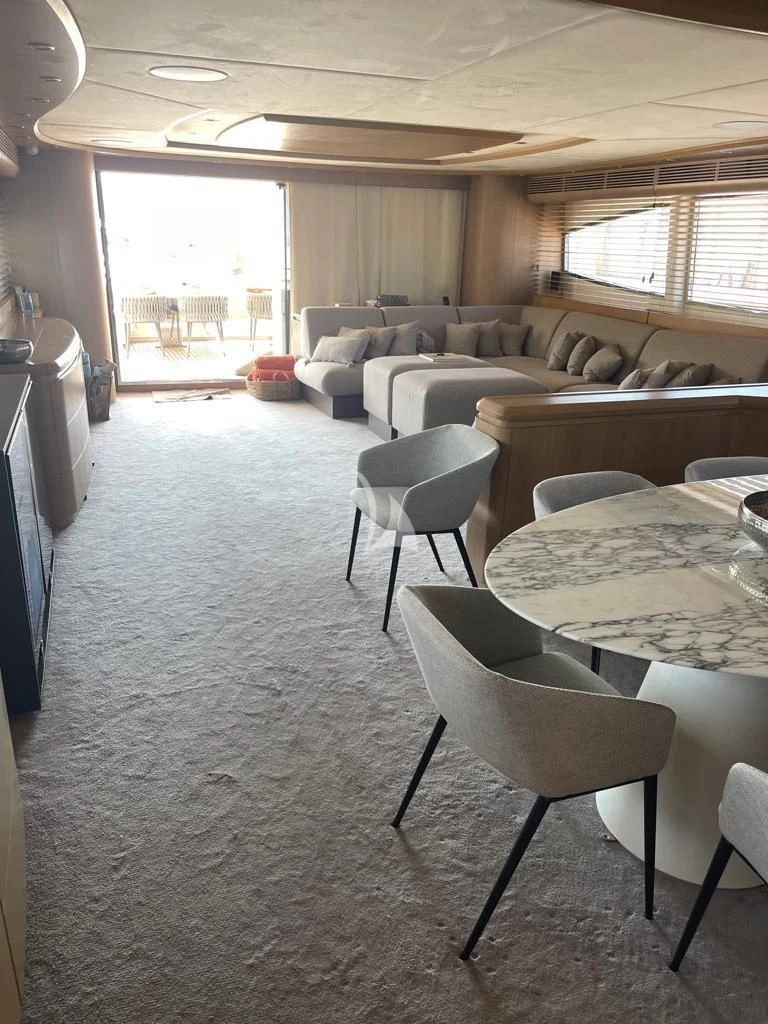 a living room with a table and chairs aboard B4 Yacht for Charter