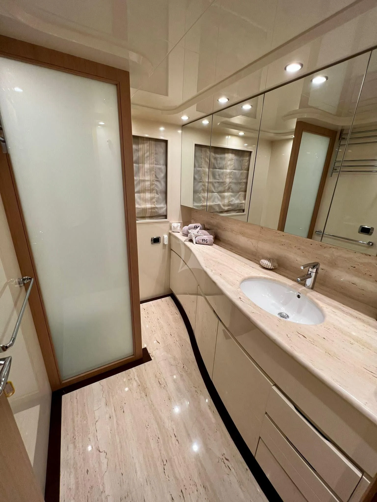 a bathroom with a sink and a mirror aboard B4 Yacht for Charter